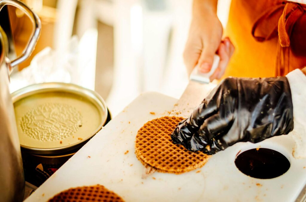 A person is cutting waffles on a cutting board