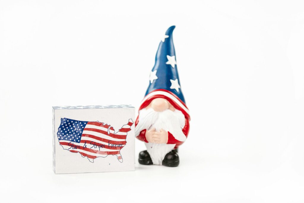 A Miniature of a Man Wearing a Hat with Stars Beside a Box with a Flag