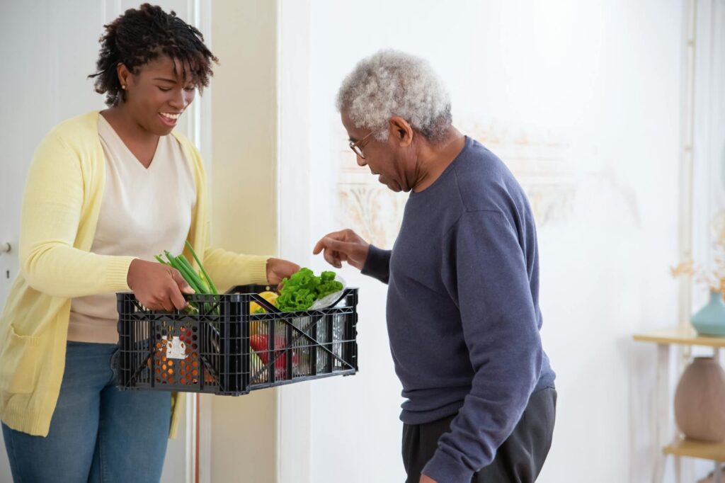 A Woman Holding a Plastic Crate with Fruits and Vegetables