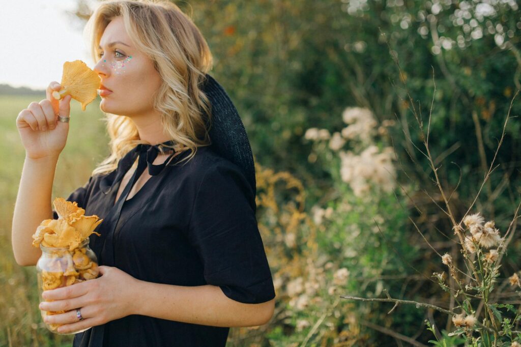 Woman in Blue Shirt Standing Near Green Plants