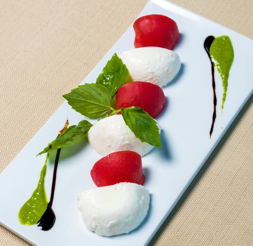 Red and White Round Fruits on White Ceramic Plate