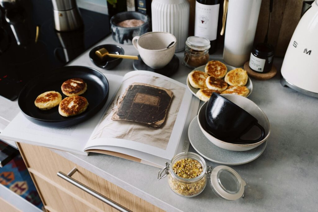 Process of making cheese pancakes with ingredients for recipe in modern kitchen