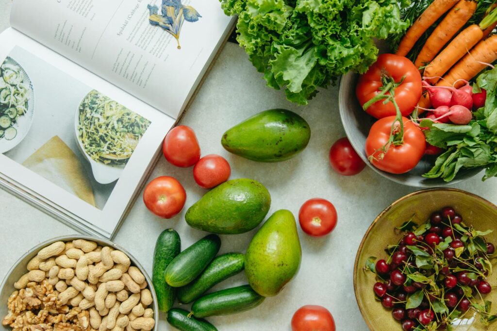 Top View of a Cookbook and Variety of Healthy Foods on a Table