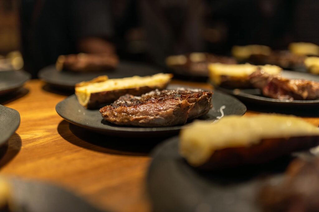 A plate of steak and bread on a table